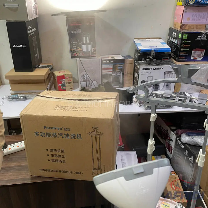 Cardboard box containing a garment steamer