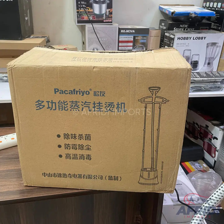 Cardboard box containing a Pacafriyo brand multi-function garment steamer.
