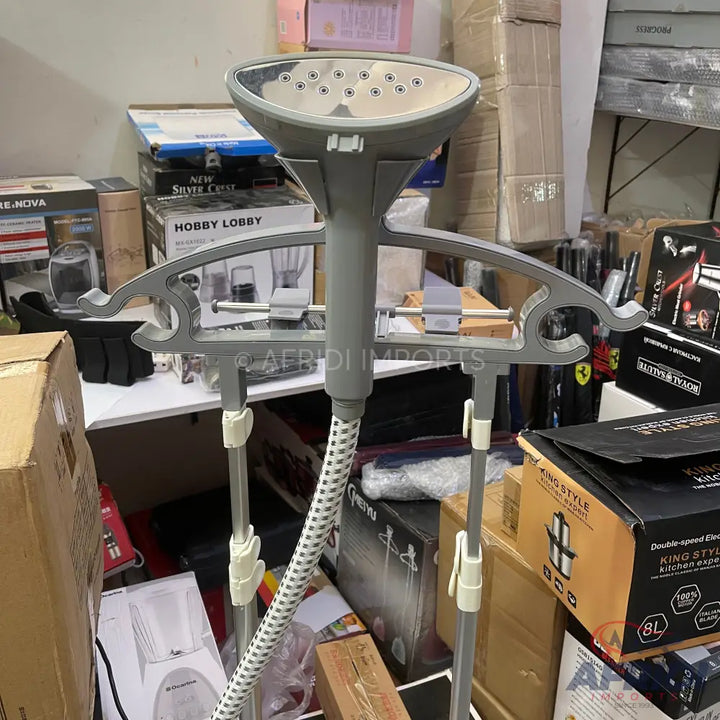 Gray garment steamer with a wide steam head and an adjustable hanger.
