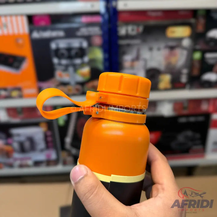An orange and black water bottle with a carrying loop.