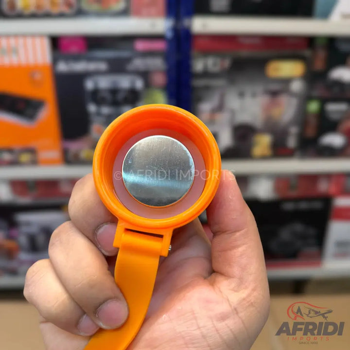 An orange and silver magnetic bottle opener.