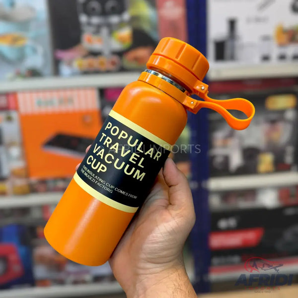 Orange travel vacuum cup with a handle.