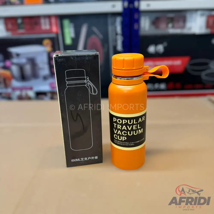 Orange travel vacuum cup with a black box.
