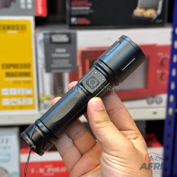 Black handheld tactical flashlight with a side power button and battery indicator.