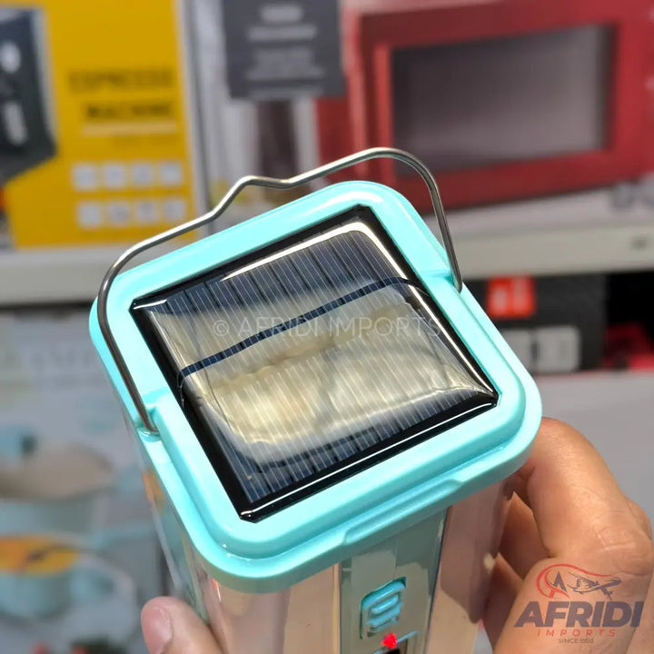 A light blue and clear plastic solar-powered lantern with a metal carrying handle.