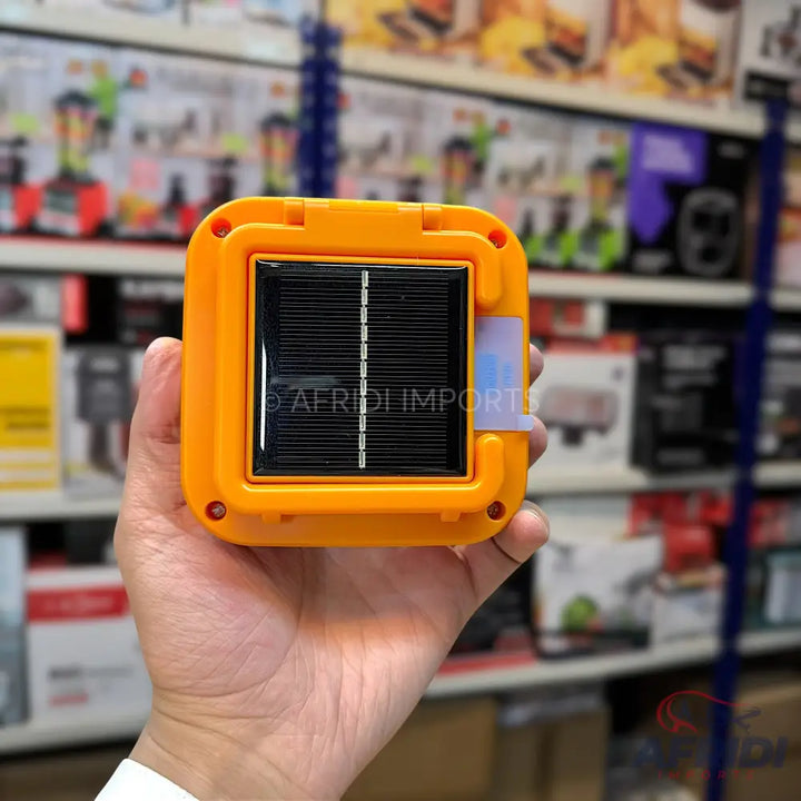 A bright orange solar-powered portable light.