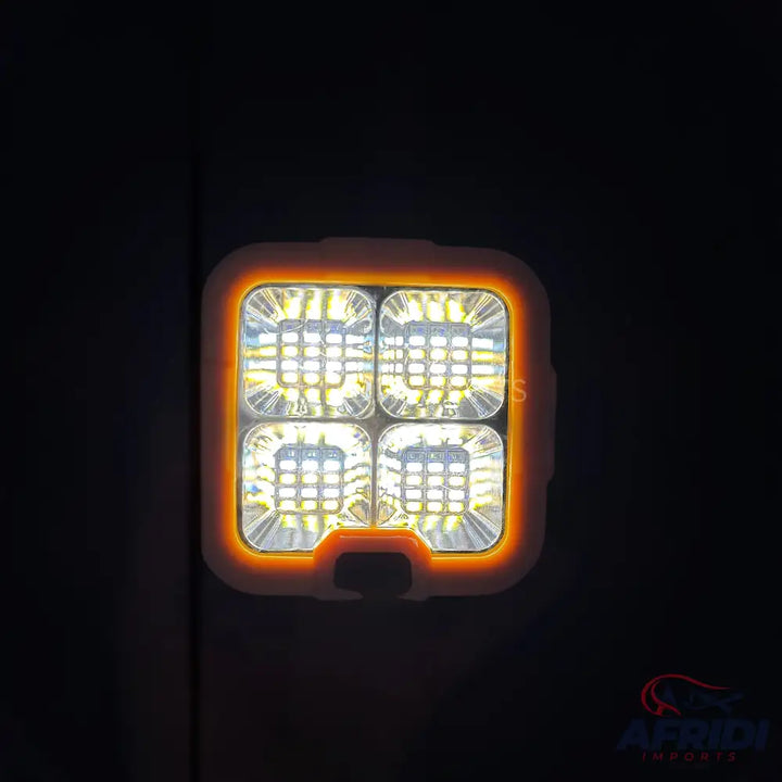 Square LED light with an orange halo.