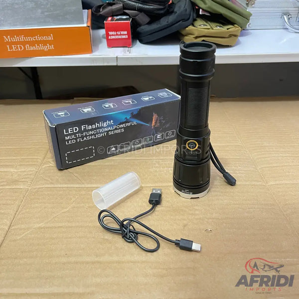 Black LED flashlight with a ribbed grip and a charging cable.