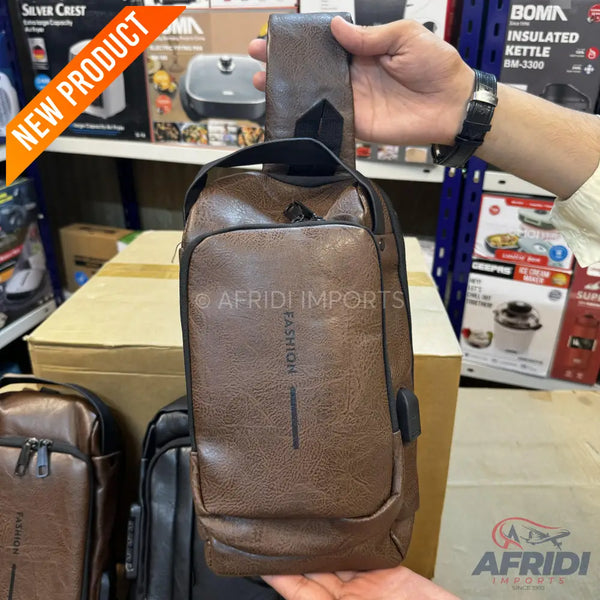 Brown faux leather sling bag with a USB charging port.
