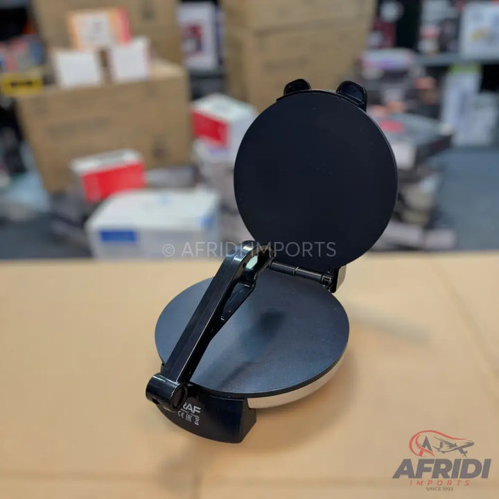 Black, round, electric tortilla or chapati maker with a hinged lid.