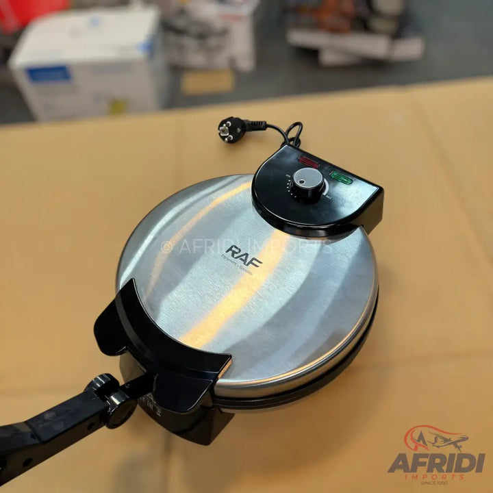 Silver and black electric waffle maker with temperature control.