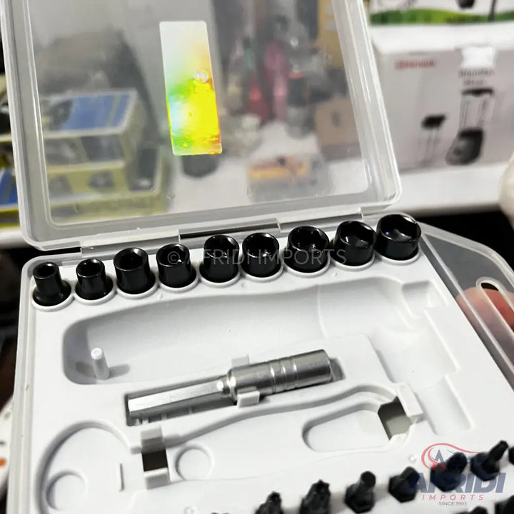 A white plastic case holding various black and silver drill bits and tools.