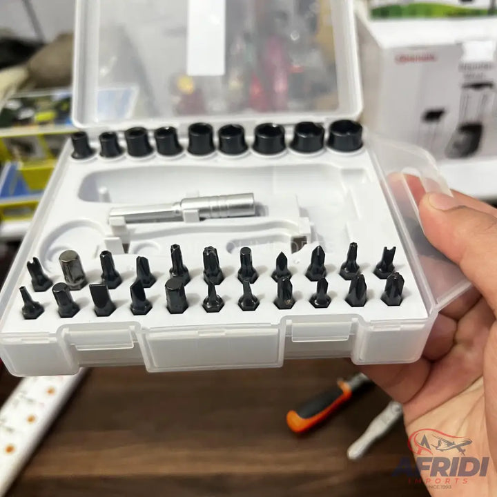 A white plastic case containing various screwdriver bits, sockets, and an extender.
