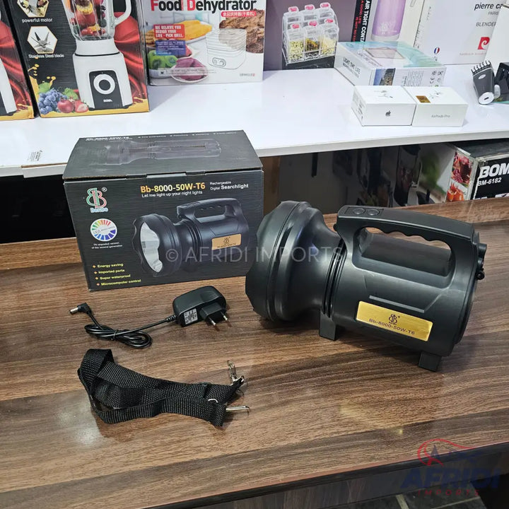 Powerful black rechargeable spotlight with a handle and shoulder strap.