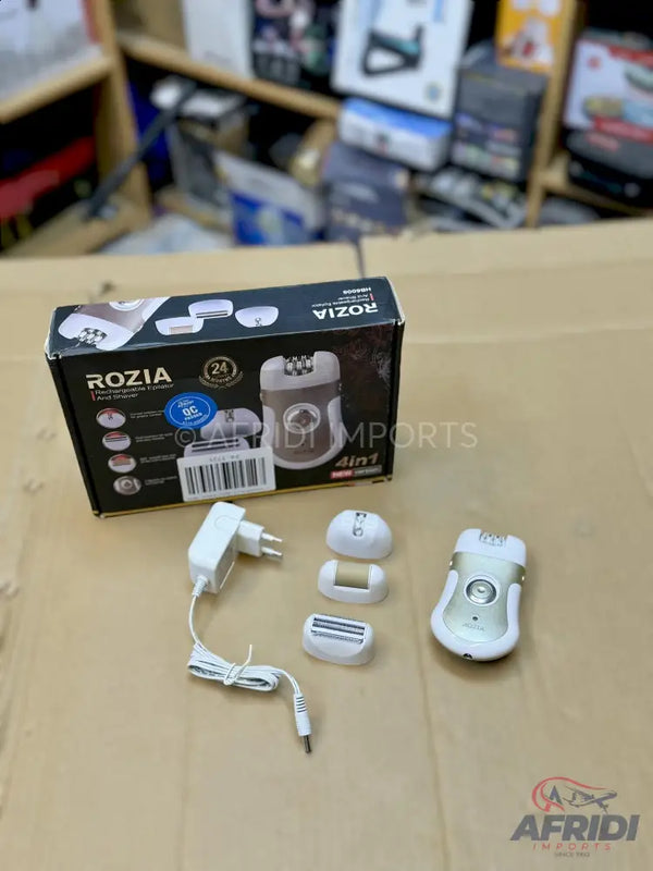 A white and gold epilator kit with multiple attachments and a charger.