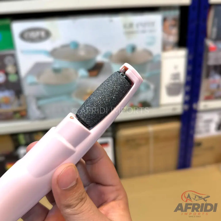 Handheld electric foot file with a coarse grey roller.