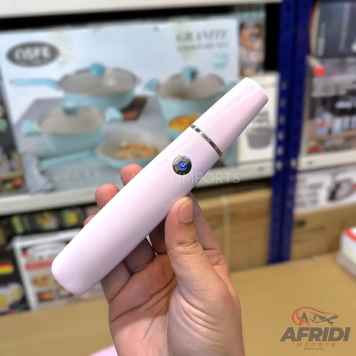 A light pink ultrasonic skin scrubber with a metallic power button.