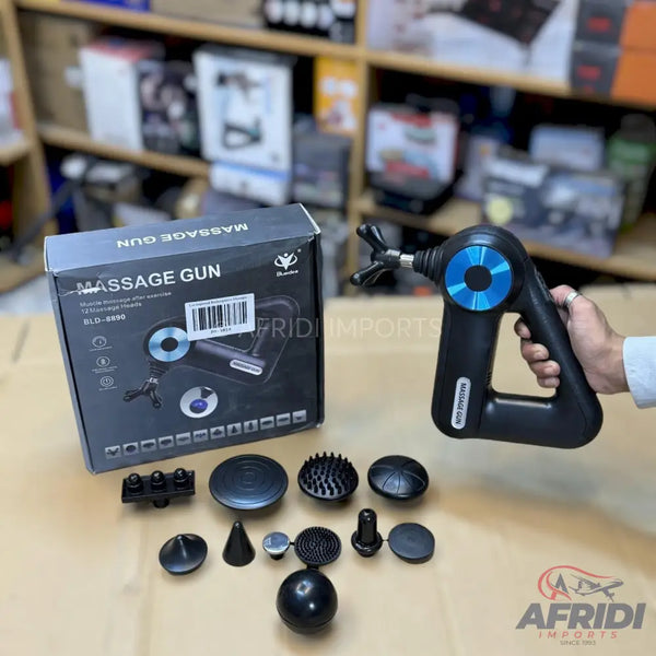 Black massage gun with multiple interchangeable head attachments and its packaging.