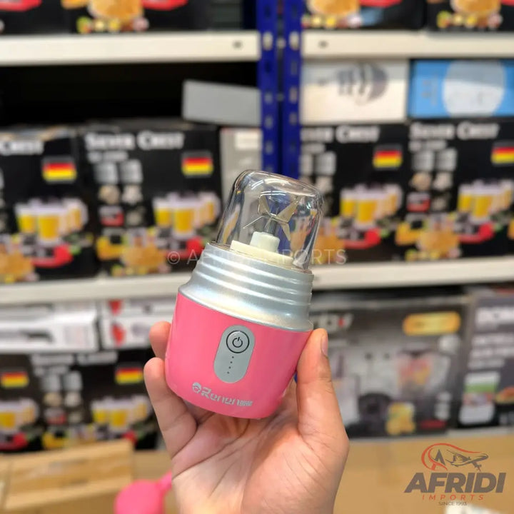 Pink portable blender with a clear top and silver base.