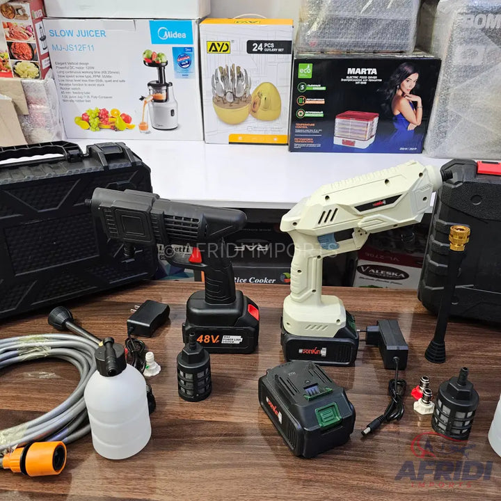 Two portable, battery-powered pressure washers with accessories.