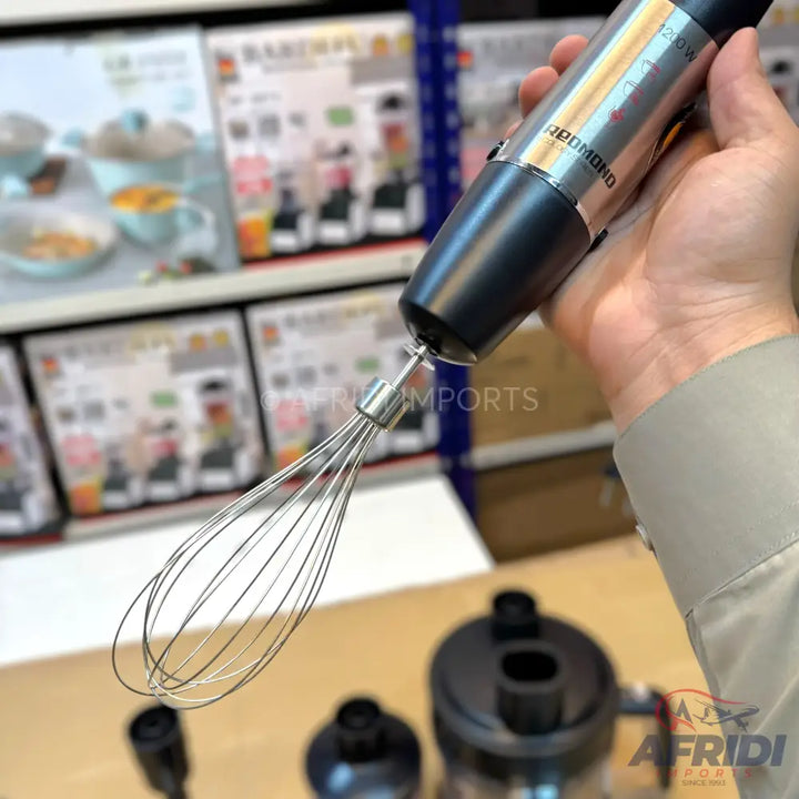 A hand-held immersion blender with a whisk attachment.