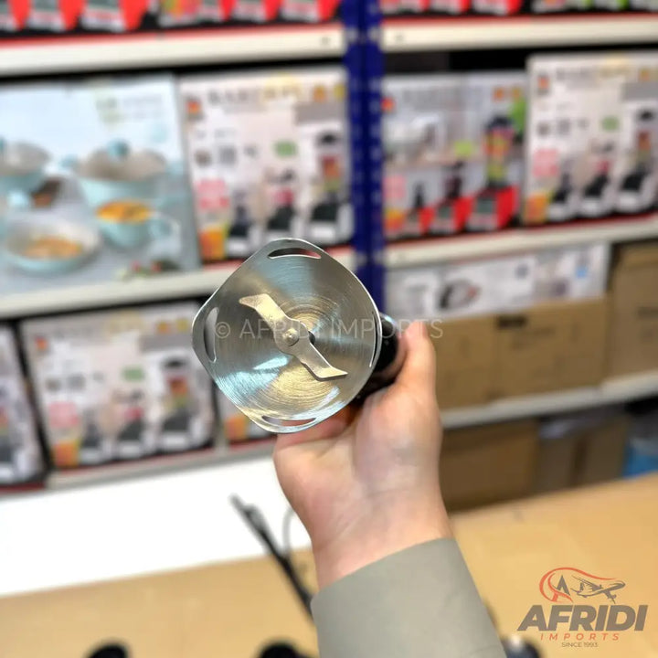 Handheld immersion blender with a two-pronged blade.