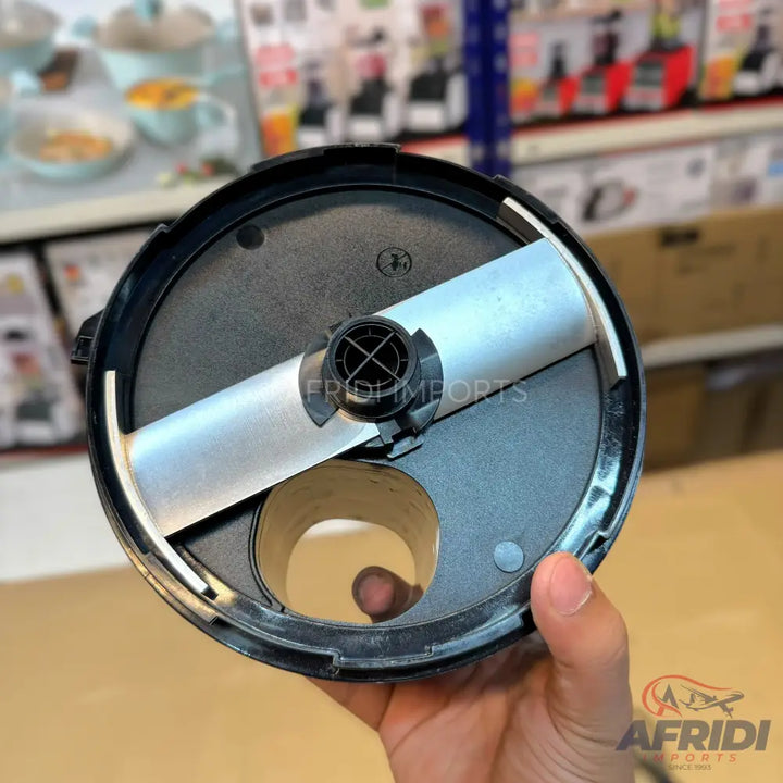 A black food processor lid with a rotating metal blade and an opening.