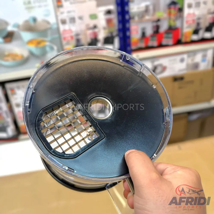 A clear plastic lid with a black center and a gridded opening, designed for a food processor or similar kitchen appliance.