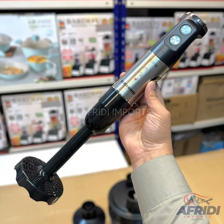 A hand-held immersion blender with a black handle and a silver body, featuring two light blue control buttons.