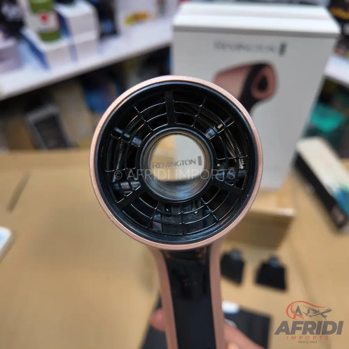 Rose gold and black hair dryer with a central air outlet.