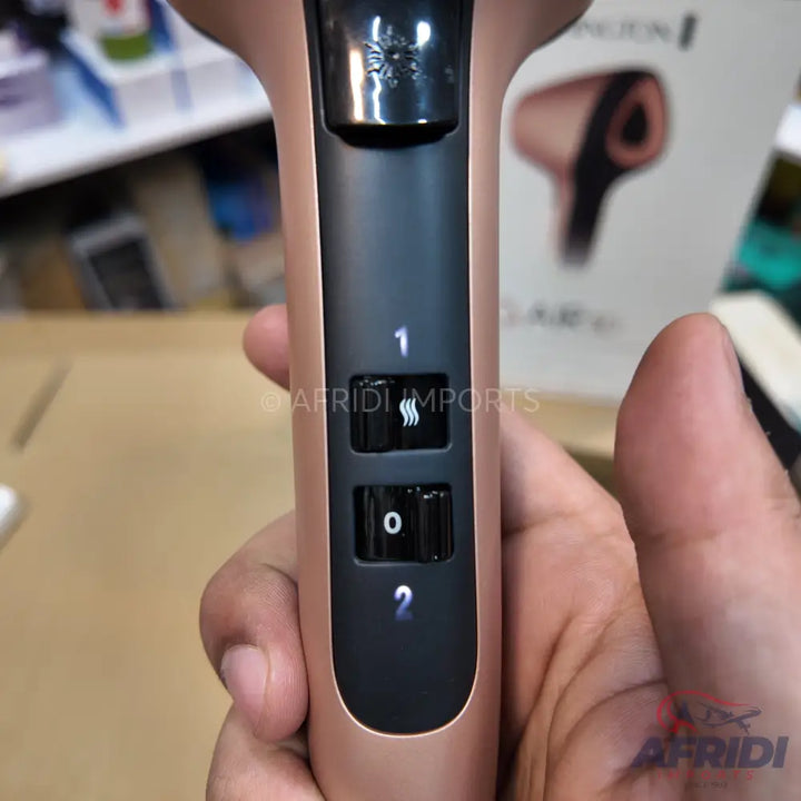 Rose gold hair dryer with three heat/speed settings.