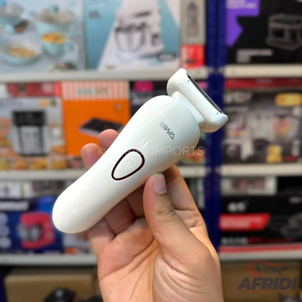 White handheld electric shaver with a single power button.