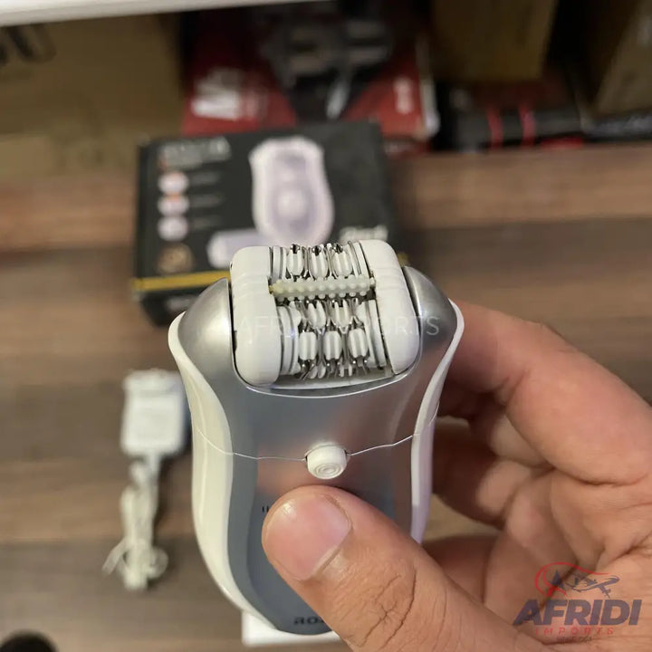 A white and silver electric epilator with a multi-tweezer head, designed for hair removal.