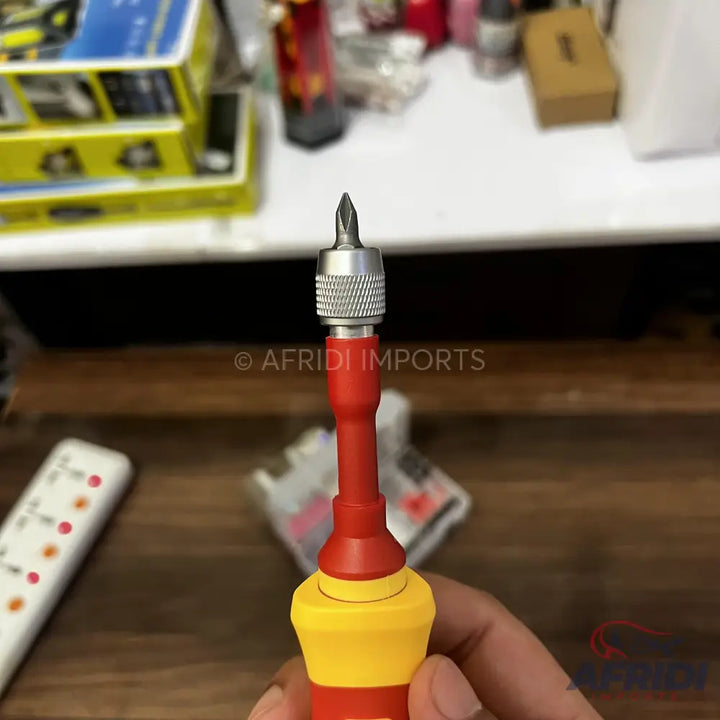 Red and yellow insulated screwdriver with a removable bit.