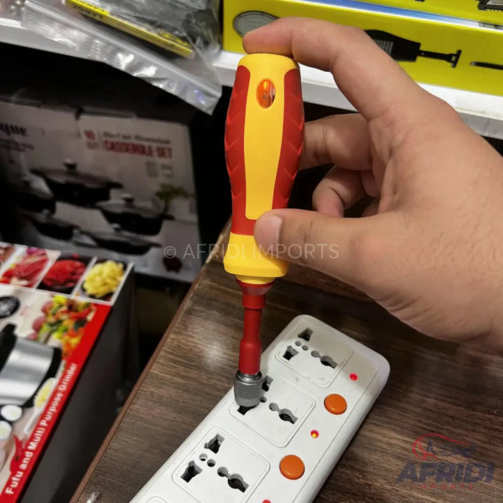 An electrician’s test screwdriver with a red and yellow insulated handle, inserted into a power strip.