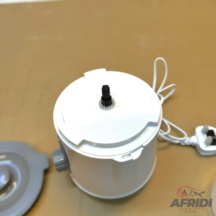White electric food processor base with a black spindle and an attached power cord.
