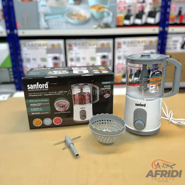 A white and gray electric food chopper with a clear bowl and a separate blade attachment.