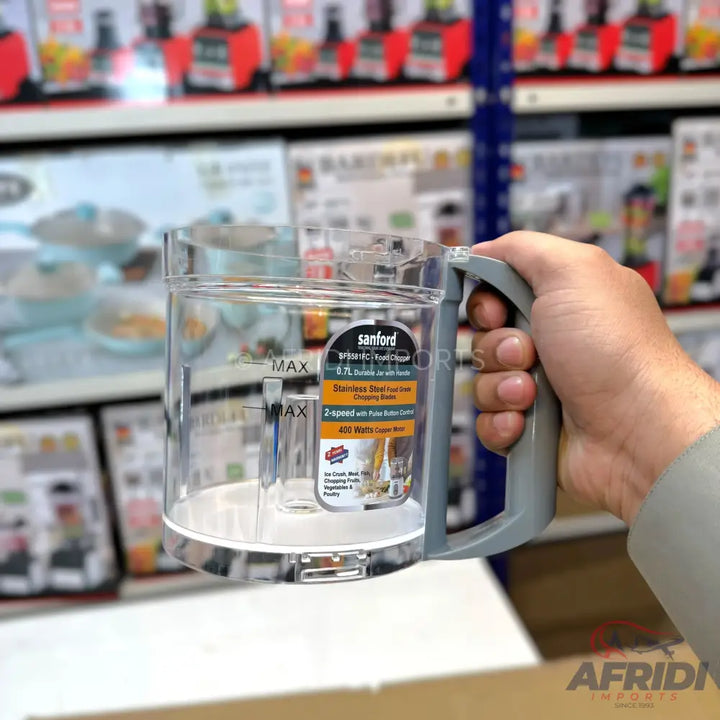 A clear plastic food processor chopping bowl with a grey handle.