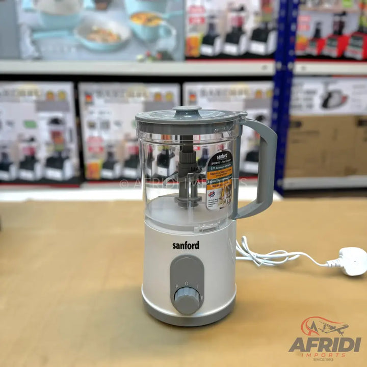 White and grey food processor with a clear blending jug and a control knob.