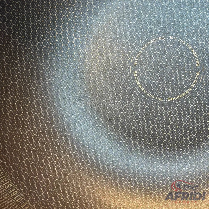 A textured, metallic cooking surface with a hexagonal pattern.
