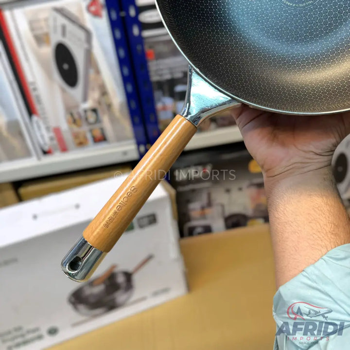 A non-stick frying pan with a wooden handle.