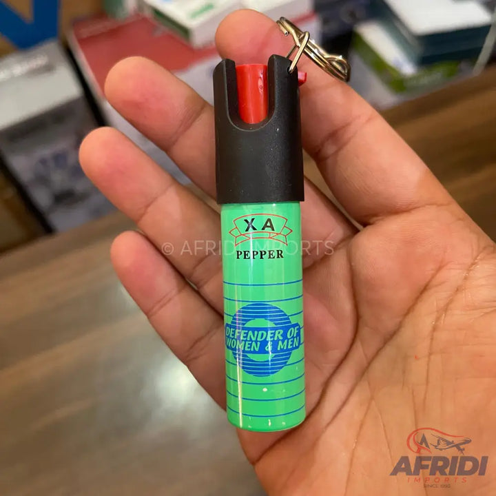 A green pepper spray canister with a black top and a red button.