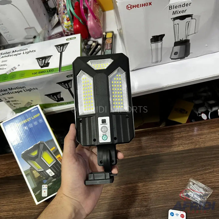 Solar-powered outdoor motion sensor light with multiple LED panels and an adjustable bracket.