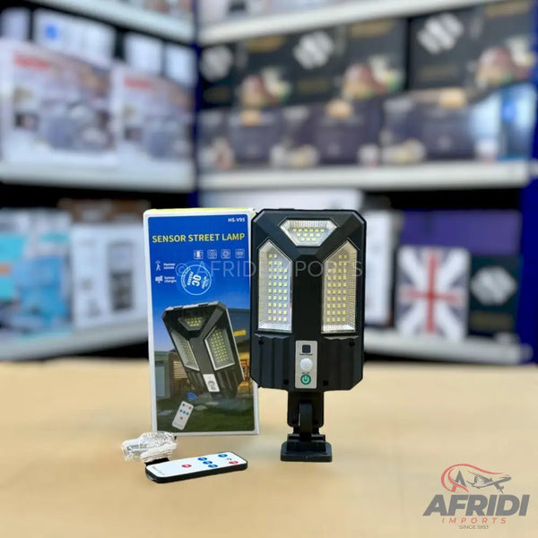 Black solar-powered LED street lamp with a remote control.
