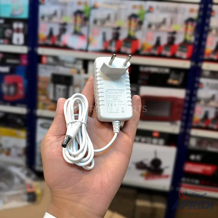 White AC power adapter with a two-prong plug and a coiled DC output cable.