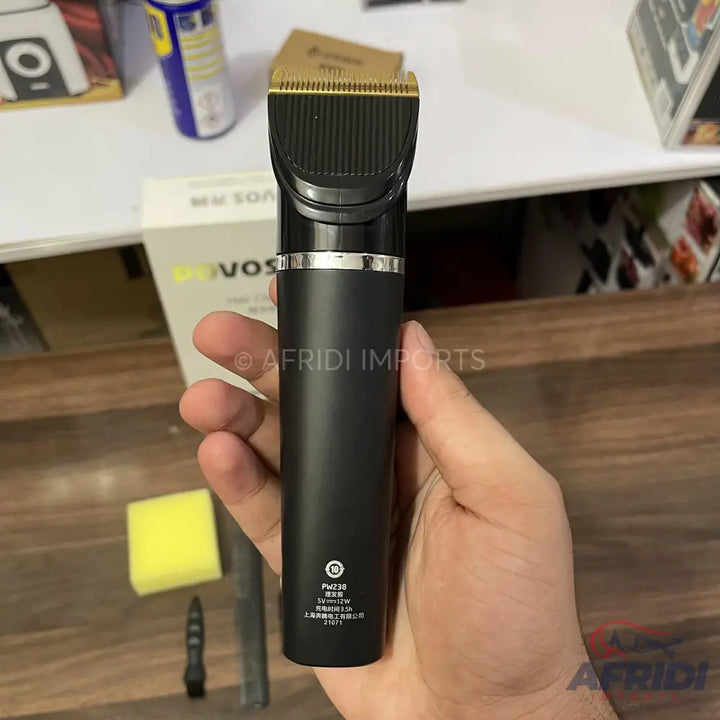 Matte black hair clipper with a gold-colored blade.
