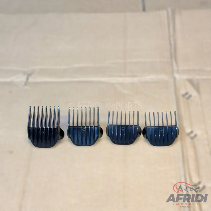 Four metal hair clipper guards of varying sizes.