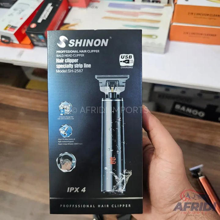 A boxed electric hair clipper with a silver and black design, USB charging, and an IPX4 waterproof rating.
