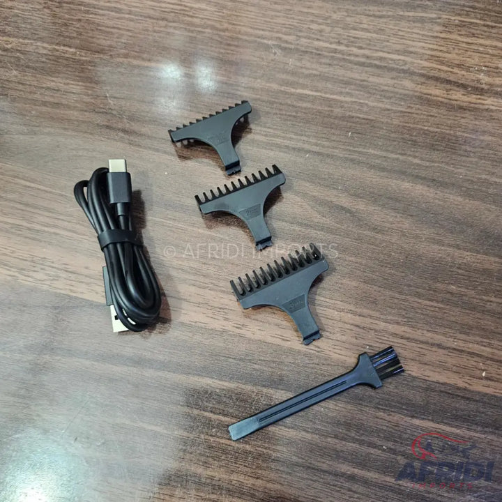 Hair clipper accessories including guide combs, a cleaning brush, and a USB charging cable.