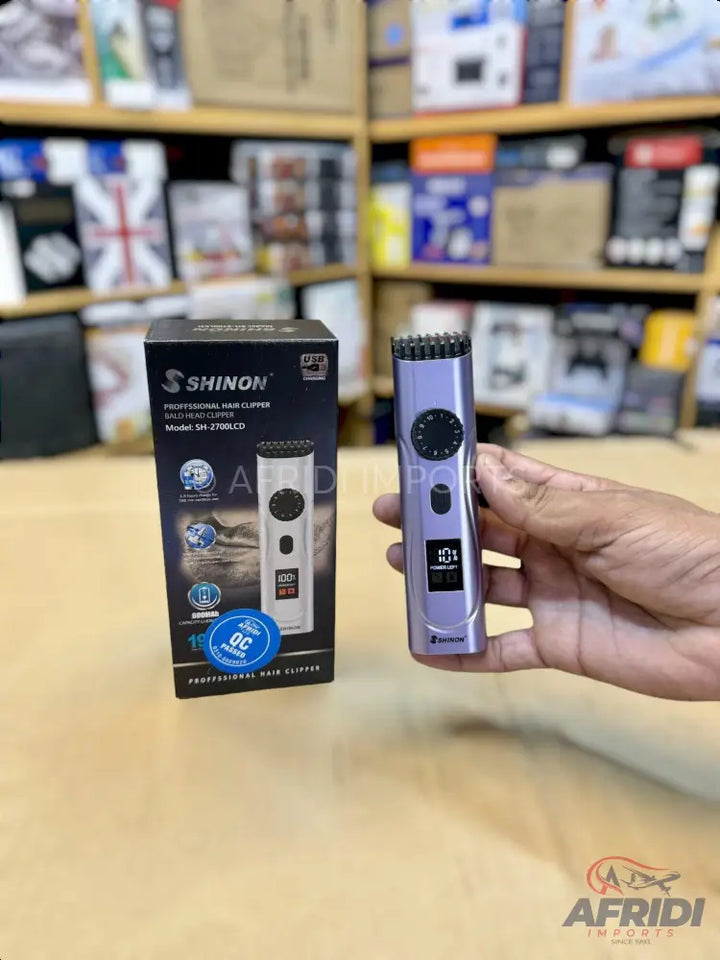 Purple electric hair trimmer with digital display and adjustable settings.